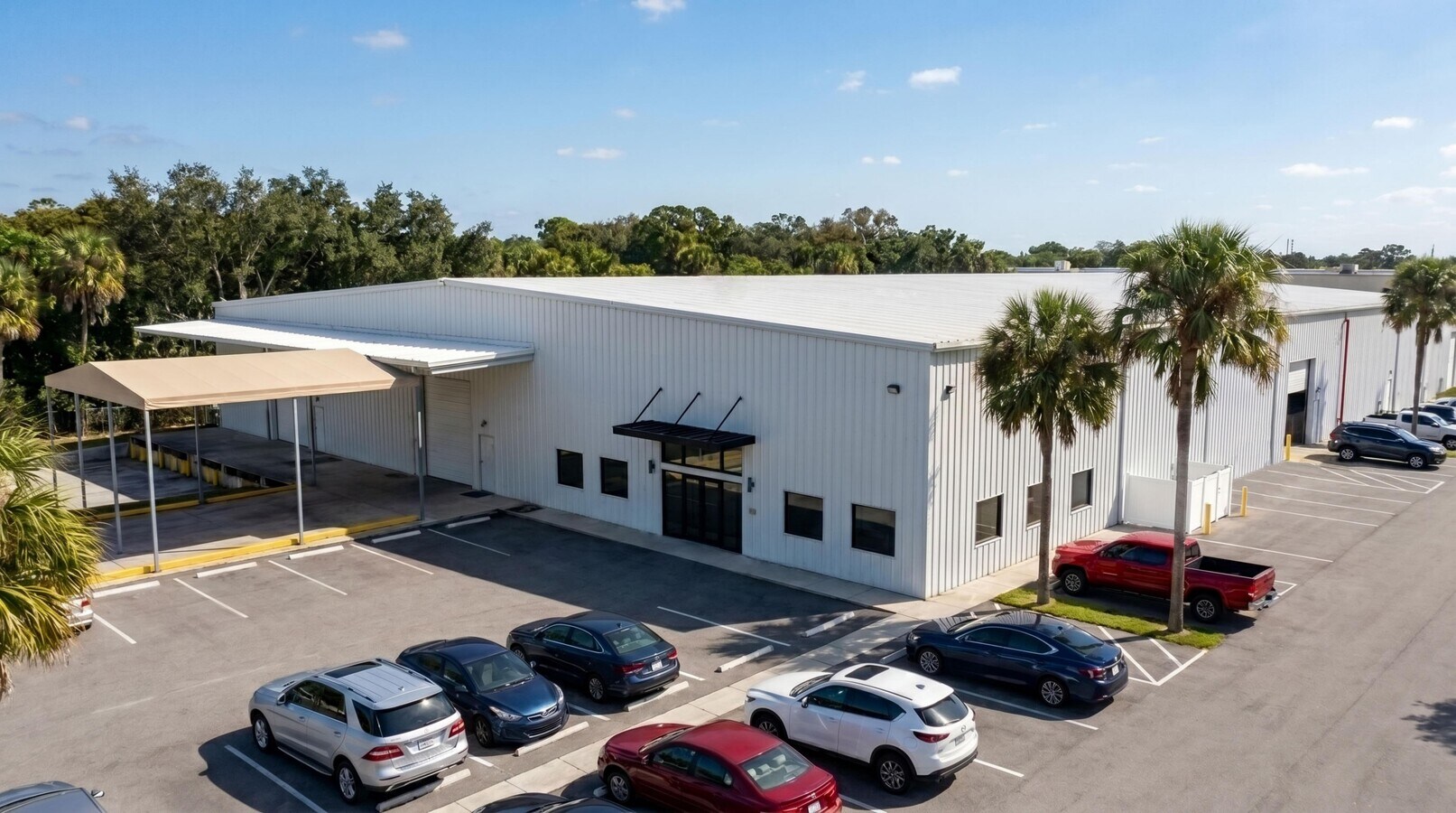 Front elevation with the covered loading/staging canopy — 198 Lock Road, Deerfield Beach, FL